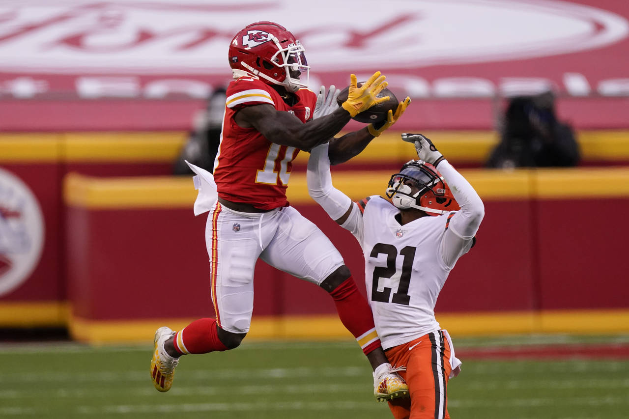 FILE - Kansas City Chiefs wide receiver Tyreek Hill makes a catch over Cleveland Browns cornerback ...