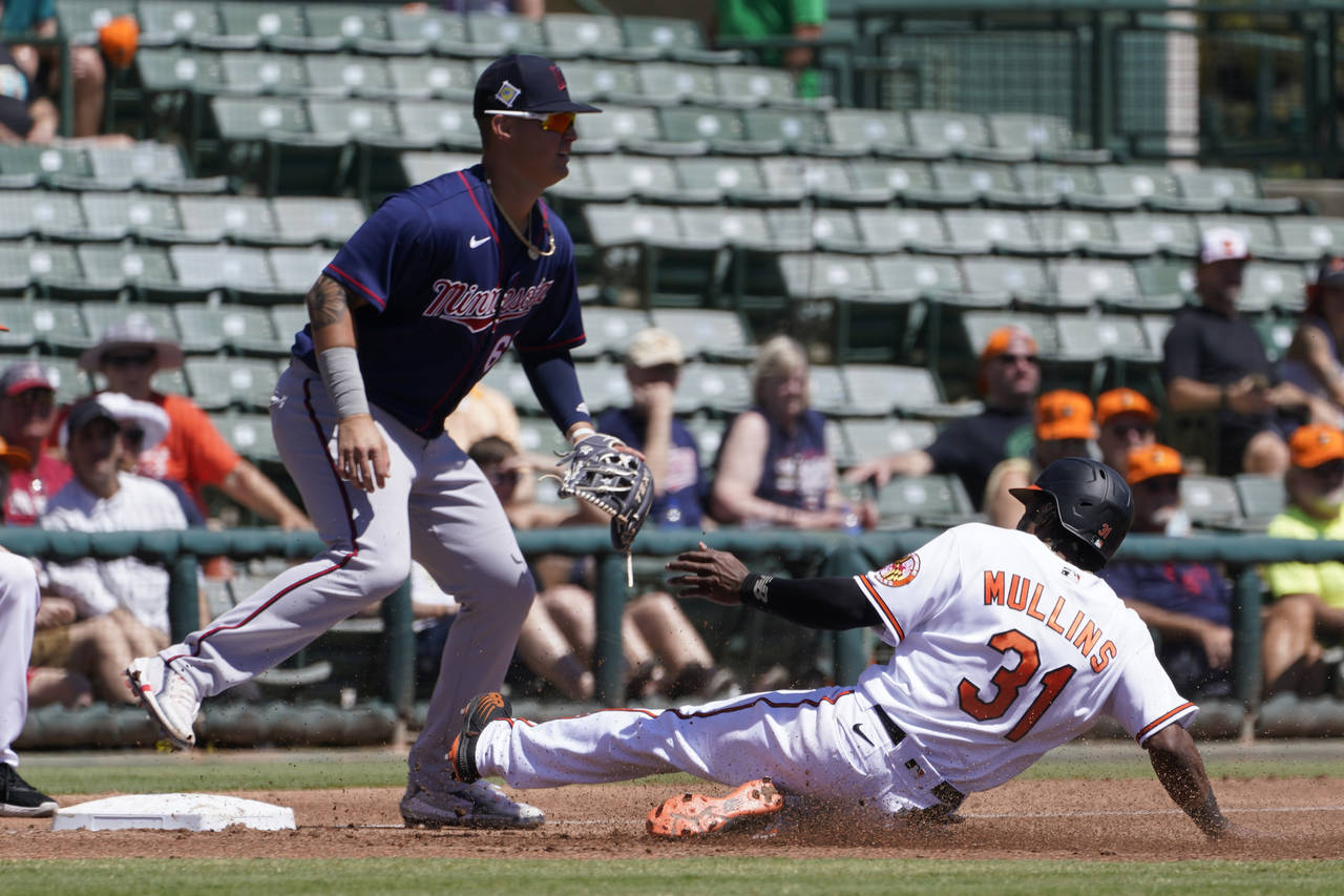 Baltimore Orioles' Cedric Mullins (31) slides into third base as Minnesota Twins third baseman Jose...
