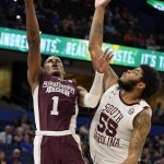 
              Mississippi State guard Iverson Molinar (1) goes up against South Carolina forward Ta'Quan Woodley (55) to shoot during the first half of an NCAA men's college basketball game at the Southeastern Conference tournament in Tampa, Fla., Thursday, March 10, 2022. (AP Photo/Chris O'Meara)
            