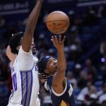 
              New Orleans Pelicans guard Devonte' Graham goes to the basket against Sacramento Kings center Damian Jones in the second half of an NBA basketball game in New Orleans, Wednesday, March 2, 2022. The Pelicans won 125-95. (AP Photo/Gerald Herbert)
            