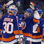 
              New York Islanders center Casey Cizikas (53) and goaltender Ilya Sorokin (30) celebrate after closing the third period of an NHL hockey game against the Detroit Red Wings, Thursday, March 24, 2022, in Elmont, N.Y. (AP Photo/John Minchillo)
            