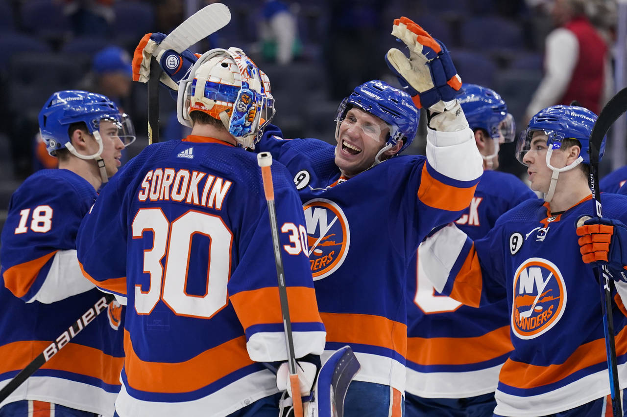 New York Islanders center Casey Cizikas (53) and goaltender Ilya Sorokin (30) celebrate after closi...