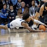 
              Villanova guard Jordan Longino, left, and Providence forward Ed Croswell (5) converge on a loose ball during the first half of an NCAA college basketball game, Tuesday, March 1, 2022, in Villanova, Pa. (AP Photo/Laurence Kesterson)
            