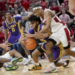 
              Arkansas guard JD Notae (1) and LSU center Efton ReidIII (15) fight for control of the ball during the first half of an NCAA college basketball game Wednesday, March 2, 2022, in Fayetteville, Ark. (AP Photo/Michael Woods)
            