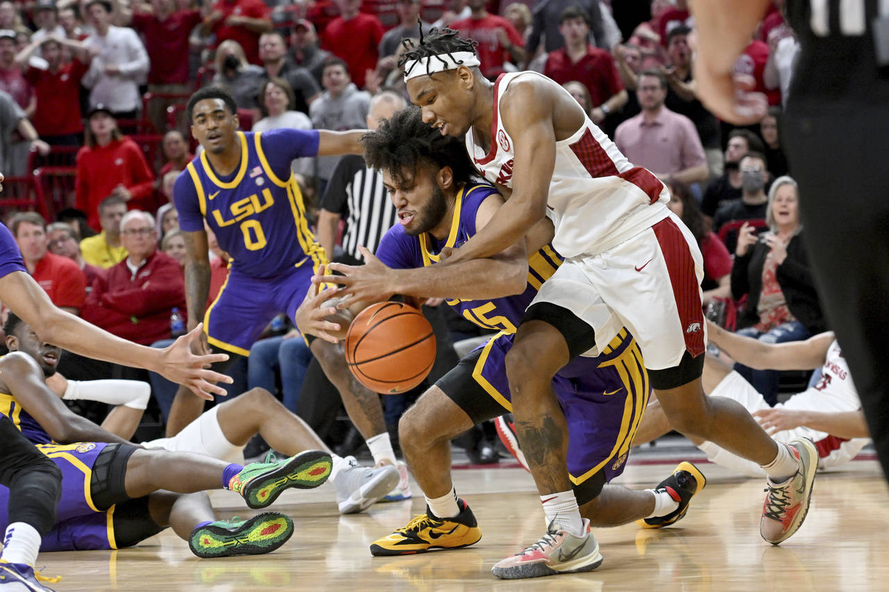 Arkansas guard JD Notae (1) and LSU center Efton ReidIII (15) fight for control of the ball during ...