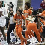 
              Miami forward Destiny Harden, center, reacts after making the game-winning shot as time expired in the second half of an NCAA college basketball quarterfinal game against Louisville at the Atlantic Coast Conference women's tournament in Greensboro, N.C., Friday, March 4, 2022. (AP Photo/Gerry Broome)
            