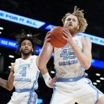 
              North Carolina's Brady Manek (45) rebounds alongside North Carolina's R.J. Davis (4) in the first half of an NCAA college basketball game during semifinals of the Atlantic Coast Conference men's tournament, Friday, March 11, 2022, in New York. (AP Photo/John Minchillo)
            