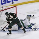 
              Minnesota Wild's Joel Eriksson Ek (14) shoots the puck past Vancouver Canucks goalie Thatcher Demko to score in overtime of an NHL hockey game Thursday, March 24, 2022, in St. Paul, Minn. The Wild won 3-2. (AP Photo/Craig Lassig)
            