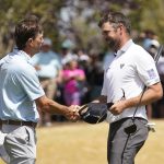 
              Corey Conners, right, shakes hands after losing to Kevin Kisner, left, in the semifinal round of the Dell Technologies Match Play Championship golf tournament, Sunday, March 27, 2022, in Austin, Texas. (AP Photo/Tony Gutierrez)
            