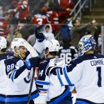 
              Winnipeg Jets players celebrate their victory against the New Jersey Devils at the end of an NHL hockey game Thursday, March 10, 2022, in Newark, N.J. The Jets won 2-1. (AP Photo/Eduardo Munoz Alvarez)
            