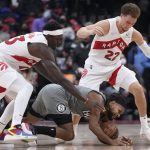 
              Brooklyn Nets guard Patty Mills tries to get possession of the ball against Toronto Raptors forward Pascal Siakam (43) and guard Malachi Flynn (22) during the first half of an NBA basketball game Tuesday, March 1, 2022, in Toronto. (Nathan Denette/The Canadian Press via AP)
            