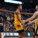 
              Iowa's Connor McCaffery, right, talks to Keegan Murray as Richmond huddles in the second half of a college basketball game during the first round of the NCAA men's tournament, Thursday, March 17, 2022, in Buffalo, N.Y. (AP Photo/Frank Franklin II)
            
