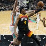 
              Utah Jazz guard Trent Forrest (3) drives to the basket against San Antonio Spurs center Jakob Poeltl, center, during the second half of an NBA basketball game, Friday, March 11, 2022, in San Antonio. (AP Photo/Eric Gay)
            