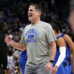 
              FILE - Dallas Mavericks team owner Mark Cuban celebrates on the court during a time out after the Mavericks took the lead in the second half of an NBA basketball game against the Sacramento Kings in Dallas, Saturday, March, 5, 2022. (AP Photo/Tony Gutierrez, File)
            