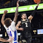 
              Vanderbilt guard Scotty Pippen Jr. (2) drives to the basket against Florida guard Niels Lane (44) during the first half of an NCAA college basketball game Tuesday, March 1, 2022, in Nashville, Tenn. (AP Photo/Mark Zaleski)
            