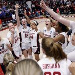 
              Stanford's Lexie Hull (12), center, celebrates with teammates after defeating Kansas in a second-round game in the NCAA women's college basketball tournament Sunday, March 20, 2022, in Stanford, Calif. (Carlos Avila Gonzalez/San Francisco Chronicle via AP)
            