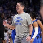 
              Dallas Mavericks team owner Mark Cuban celebrates on the court during a time out after the Mavericks took the lead in the second half of an NBA basketball game against the Sacramento Kings in Dallas, Saturday, March, 5, 2022. (AP Photo/Tony Gutierrez)
            