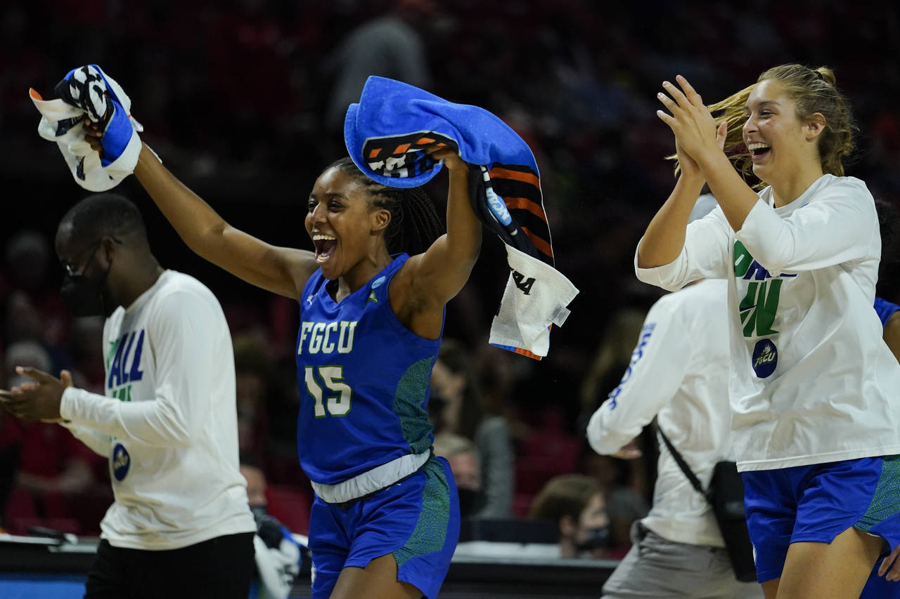 Florida Gulf Coast guard Tyra Cox (15) and teammates celebrate after defeating Virginia Tech during...