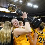 
              Iowa forward Monika Czinano holds the trophy after an NCAA college basketball game against Michigan, Sunday, Feb. 27, 2022, in Iowa City, Iowa. Iowa won 104-80. The victory gave Iowa a share of the Big Ten Conference championship. (AP Photo/Charlie Neibergall)
            