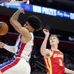 
              Detroit Pistons guard Killian Hayes (7) dunks as Atlanta Hawks guard Kevin Huerter (3) defends during the first half of an NBA basketball game, Wednesday, March 23, 2022, in Detroit. (AP Photo/Carlos Osorio)
            