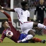 
              Costa Rica's Brandon Aguilera, below, and United States' Yunus Musah battle for the ball during a qualifying soccer match for the FIFA World Cup Qatar 2022 in San Jose, Costa Rica, Wednesday, March 30, 2022. (AP Photo/Moises Castillo)
            