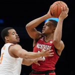 
              North Carolina State's Casey Morsell (14) looks to pass over Clemson Tigers' Nick Honor (4) during the first half of an NCAA college basketball game of the Atlantic Coast Conference men's tournament, Tuesday, March 8, 2022, in New York. (AP Photo/John Minchillo)
            