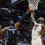 
              Miami Heat center Dewayne Dedmon (21) attempts to block a shot to the basket by Sacramento Kings forward Chimezie Metu (7) during the first half of an NBA basketball game, Monday, March 28, 2022, in Miami. (AP Photo/Marta Lavandier)
            