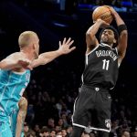 
              Brooklyn Nets guard Kyrie Irving (11) shoots over Charlotte Hornets forward P.J. Washington, left, in the second half of an NBA basketball game, Sunday, March 27, 2022, in New York. (AP Photo/John Minchillo)
            