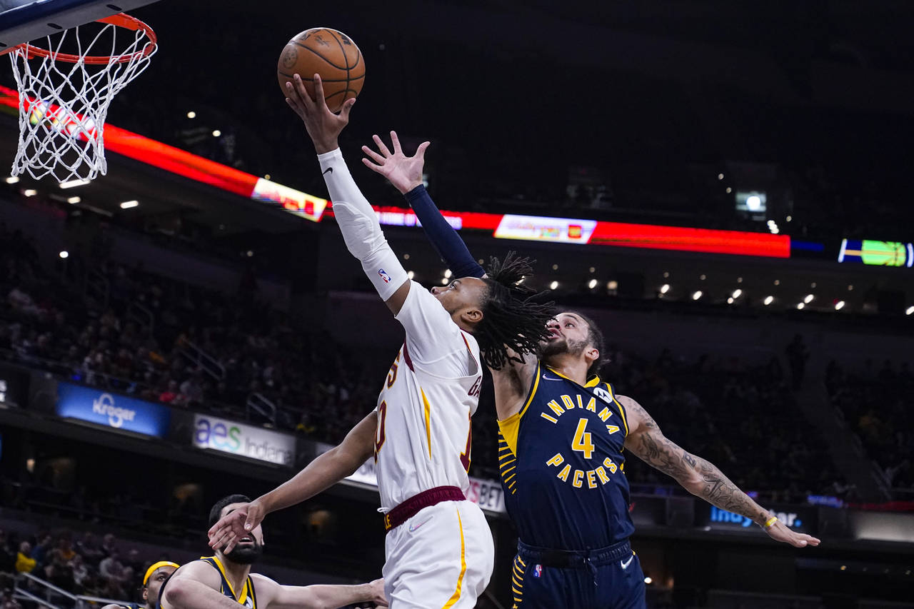 Cleveland Cavaliers guard Darius Garland (10) shoots in front of Indiana Pacers guard Duane Washing...
