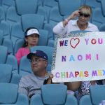 
              Fans of Naomi Osaka of Japan hold up a sign before the start of Osaka's match against Alison Riske, during the Miami Open tennis tournament, Monday, March 28, 2022, in Miami Gardens, Fla. (AP Photo/Wilfredo Lee)
            