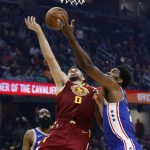 
              Cleveland Cavaliers' Kevin Love (0) and Philadelphia 76ers' Joel Embiid vie for a rebound during the first half of an NBA basketball game Wednesday, March 16, 2022, in Cleveland. (AP Photo/Ron Schwane)
            