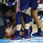 
              Connecticut guard Evina Westbrook (22) checks on forward Dorka Juhasz after Juhasz was injured on a play during the second quarter against NC State in the East Regional final college basketball game of the NCAA women's tournament, Monday, March 28, 2022, in Bridgeport, Conn. (AP Photo/Frank Franklin II)
            