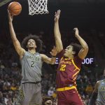
              Baylor guard Kendall Brown (2) shoots against Iowa State forward Robert Jones (12) as Baylor's Flo Thamba (0) looks on during the first half of an NCAA college basketball game in Waco, Texas, Saturday, March 5, 2022. (AP Photo/LM Otero)
            