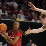 
              Georgia guard Reigan Richardson, left, grabs a rebound ahead of Iowa State guard Lexi Donarski, right, during the first half of a second-round game in the NCAA women's college basketball tournament, Sunday, March 20, 2022, in Ames, Iowa. (AP Photo/Charlie Neibergall)
            
