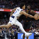 
              Dallas Mavericks guard Josh Green (8) passes the ball against Cleveland Cavaliers guard Caris LeVert (3) during the second half of an NBA basketball game Wednesday, March 30, 2022, in Cleveland. (AP Photo/Ron Schwane)
            