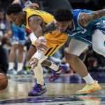 
              Utah Jazz guard Trent Forrest, left, and Charlotte Hornets forward Miles Bridges chase the ball during the first half of an NBA basketball game Friday, March 25, 2022, in Charlotte, N.C. (AP Photo/Matt Kelley)
            