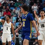 
              South Dakota State's Zeke Mayo (2) watches as Providence's Al Durham (1) and Justin Minaya (15) celebrate in the second half of a college basketball game during the first round of the NCAA men's tournament Thursday, March 17, 2022, in Buffalo, N.Y. Providence won 66-57. (AP Photo/Frank Franklin II)
            