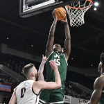 
              Jacksonville forward Osayi Osifo (15) goes up for a dunk over Bellarmine forward Ethan Claycomb (0) during the first half of an NCAA college basketball in the championship game at the ASUN conference tournament Louisville, Ky., Tuesday, March 8, 2022. (AP Photo/Timothy D. Easley)
            