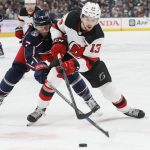 
              Columbus Blue Jackets' Sean Kuraly, left, and New Jersey Devils' Nico Hischier chase the puck during the first period of an NHL hockey game Tuesday, March 1, 2022, in Columbus, Ohio. (AP Photo/Jay LaPrete)
            