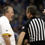 
              West Virginia head coach Bob Huggins talks to an official after being ejected from the game during the first half of an NCAA college basketball game against Kansas in the quarterfinal round of the Big 12 Conference tournament in Kansas City, Mo., Thursday, March 10, 2022. (AP Photo/Charlie Riedel)
            