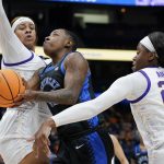 
              Kentucky's Dre'una Edwards, center, drives between LSU's Hannah Gusters, left, and Faustine Aifuwa (24) in the first half of an NCAA college basketball game at the women's Southeastern Conference tournament Friday, March 4, 2022, in Nashville, Tenn. (AP Photo/Mark Humphrey)
            