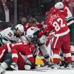 
              Detroit Red Wings and Minnesota Wild players fight at the end of the second period during an NHL hockey game Thursday, March 10, 2022, in Detroit. (AP Photo/Paul Sancya)
            