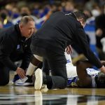 
              Duke head coach Mike Krzyzewski checks on forward AJ Griffin got injured during the second half of a college basketball game against Michigan State in the second round of the NCAA tournament on Sunday, March 20, 2022, in Greenville, S.C. (AP Photo/Chris Carlson)
            