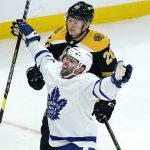 
              Toronto Maple Leafs center Colin Blackwell celebrates after his goal against Boston Bruins goaltender Jeremy Swayman during the first period of an NHL hockey game, Tuesday, March 29, 2022, in Boston. At rear is Boston Bruins center Curtis Lazar (20). (AP Photo/Charles Krupa)
            