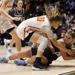 
              Columbia guard Kitty Henderson and Princeton forward Ellie Mitchell (00) scramble for the ball during the first half of an NCAA Ivy League women's college basketball championship game, Saturday, March 12, 2022, in Cambridge, Mass. (AP Photo/Mary Schwalm)
            