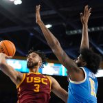 
              Southern California forward Isaiah Mobley, left shoots as UCLA center Myles Johnson defends during the first half of an NCAA college basketball game Saturday, March 5, 2022, in Los Angeles. (AP Photo/Mark J. Terrill)
            