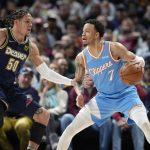 
              Los Angeles Clippers guard Amir Coffey, right, looks to pass the ball as Denver Nuggets forward Aaron Gordon defends in the first half of an NBA basketball game Tuesday, March 22, 2022, in Denver. (AP Photo/David Zalubowski)
            