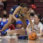 
              Georgia Tech guard Eylia Love, left, and Kansas guard Holly Kersgieter try to get control of the ball during the first half of a first-round game in the NCAA women's college basketball tournament Friday, March 18, 2022, in Stanford, Calif. (AP Photo/Tony Avelar)
            
