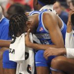 
              Memphis forward DeAndre Williams, center, sits on the bench in the final minutes of the second half of an NCAA college basketball game against Houston for the American Athletic Conference tournament championship in Fort Worth, Texas, Sunday, March 13, 2022. (AP Photo/LM Otero)
            