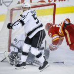 
              Los Angeles Kings defenceman Jordan Spence (53) sends Calgary Flames' Blake Coleman airborne in front of Kings goalie Cal Petersen during the third period of an NHL hockey game Thursday, March 31, 2022, in Calgary, Alberta. (Jeff McIntosh/The Canadian Press via AP)
            